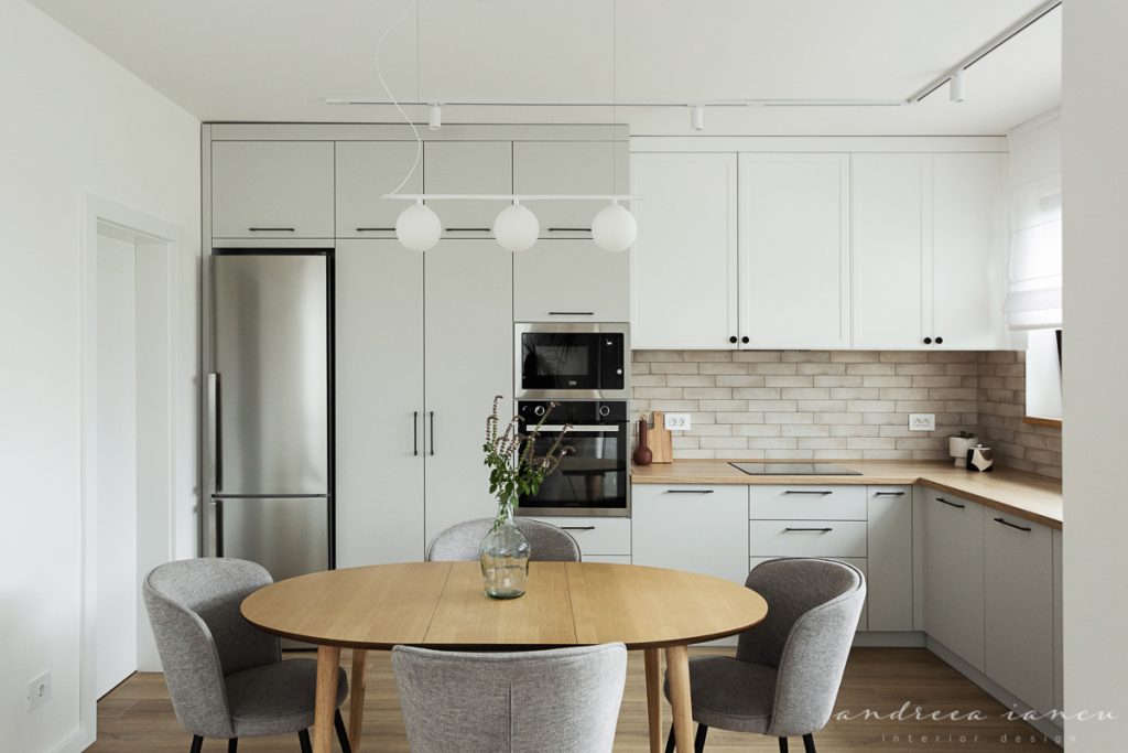 Light grey and white kitchen, with stone metro tiles backsplash.