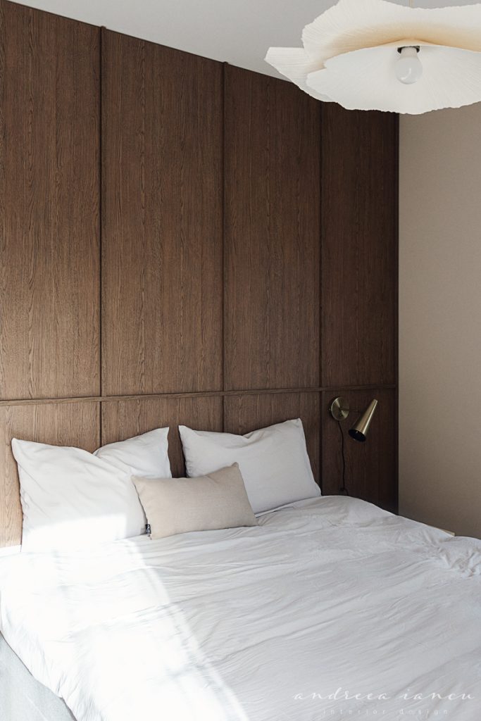 Bedroom detail view with wood wall panelling.