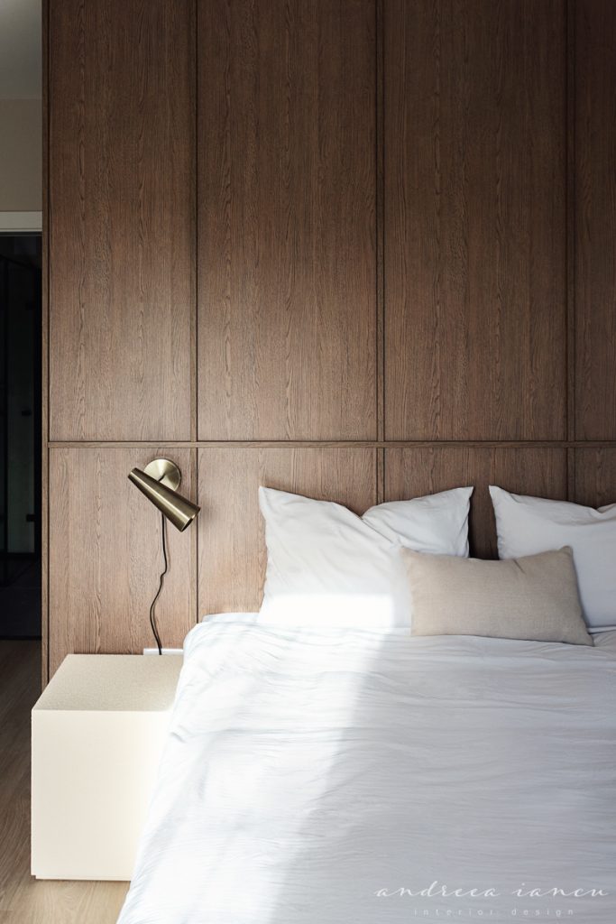 Bedroom detail view with wood wall panelling.